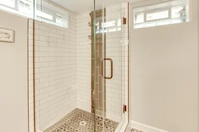 a shower with a glass door in a bathroom at Screened Patio and Fire Pit Modern Westerville Home in Westerville