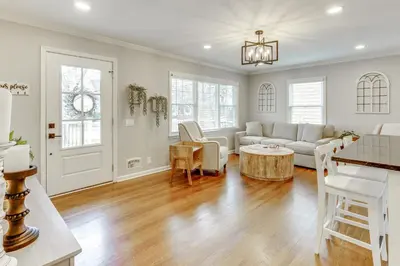 a living room with a couch and a table at Screened Patio and Fire Pit Modern Westerville Home in Westerville