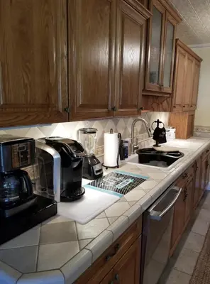 a kitchen with a counter top with a coffee maker at Lambs Landing Huron Family Vacation Home in Huron
