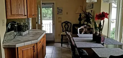 a kitchen with a counter and a table with chairs at Lambs Landing Huron Family Vacation Home in Huron