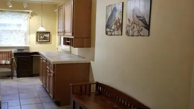 a kitchen with two pictures on the wall at Lambs Landing Huron Family Vacation Home in Huron