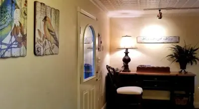 a room with a desk and a lamp next to a door at Lambs Landing Huron Family Vacation Home in Huron