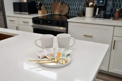 a white kitchen counter with two cups and chopsticks at Modern Lake House 3 Blocks from the Lake! in Buckeye Lake