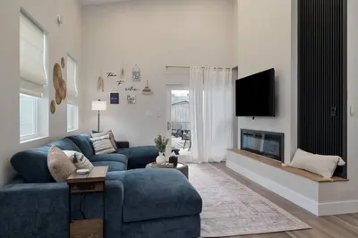 a living room with a blue couch and a tv at Modern Lake House 3 Blocks from the Lake! in Buckeye Lake