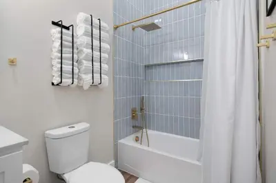 a bathroom with a white toilet and a shower at Modern Lake House 3 Blocks from the Lake! in Buckeye Lake