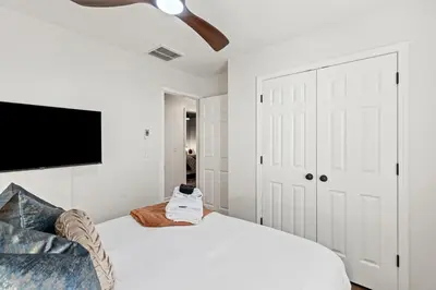 a white bedroom with a bed and a ceiling fan at The Luxe Hot Tub Playground 12 Min to Horse Park in Georgetown