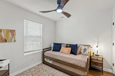 a living room with a couch and a ceiling fan at The Luxe Hot Tub Playground 12 Min to Horse Park in Georgetown