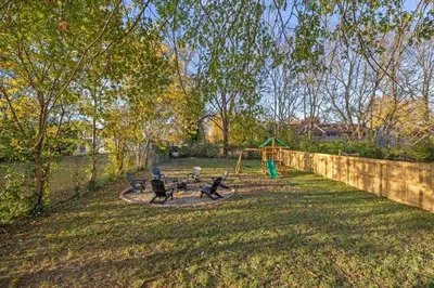 a backyard with a picnic table and a swing at The Luxe Hot Tub Playground 12 Min to Horse Park in Georgetown