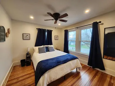 a bedroom with a bed and a ceiling fan at The Farmhouse in Elyria, OH in Elyria