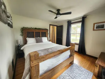 a bedroom with a bed and a ceiling fan at The Farmhouse in Elyria, OH in Elyria