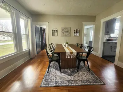 a dining room with a table and chairs at The Farmhouse in Elyria, OH in Elyria