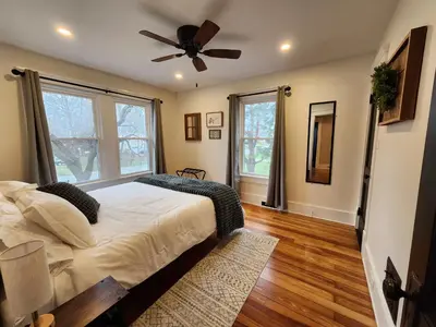 a bedroom with a bed and a ceiling fan at The Farmhouse in Elyria, OH in Elyria
