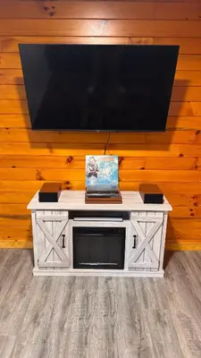 a tv on top of a wall with a table at Hot tub - Near the Gorge and Cave Run in Wellington