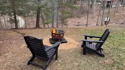two chairs and a fire grill in a yard at Hot tub - Near the Gorge and Cave Run in Wellington