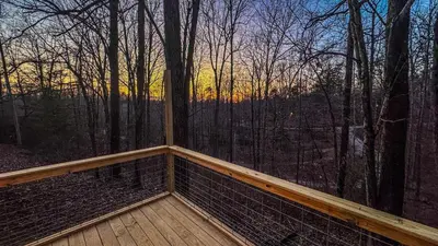 a room with a large window in the woods at Hot tub - Near the Gorge and Cave Run in Wellington