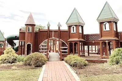 a large building with two towers and a walkway at Emerald - GREAT PARK, 3br, Yard, Pet-Friendly in Paulding