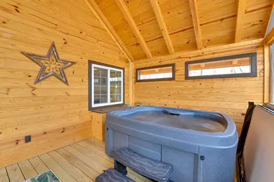 a jacuzzi tub in a log cabin at Hot Tub and Fire Pit Romantic Getaway in Frenchburg in Frenchburg