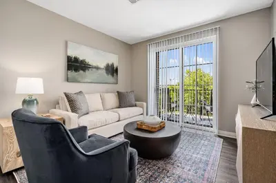 a living room with a couch and a table at City View Designer Elevator Covered Parking in Columbus