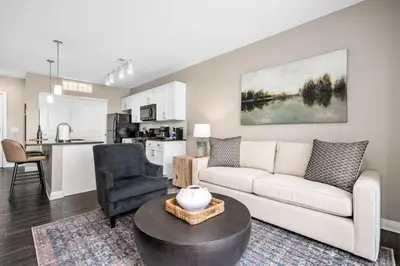 a living room with a couch and a table at City View Designer Elevator Covered Parking in Columbus