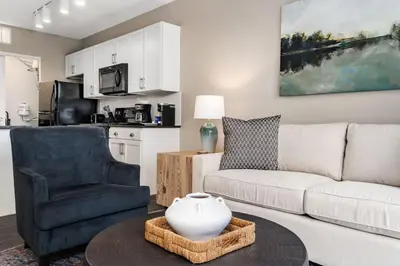 a living room with a couch and a table at City View Designer Elevator Covered Parking in Columbus