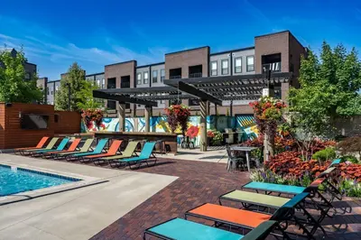a resort with lounge chairs and a swimming pool at City View Designer Elevator Covered Parking in Columbus