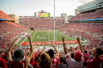 a crowd of people cheering at a football game at City View Designer Elevator Covered Parking in Columbus
