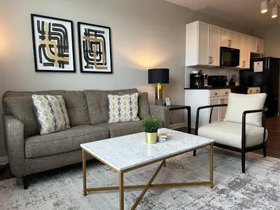 a living room with a couch and a table at Near Osu Riverside No Steps Garage Parking! in Columbus