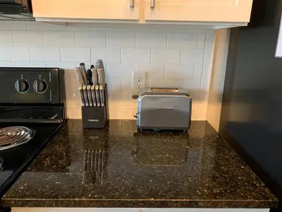 a kitchen counter with a toaster and a knife block at Near Osu Riverside No Steps Garage Parking! in Columbus