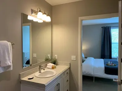 a bathroom with a sink and a mirror and a bed at Near Osu Riverside No Steps Garage Parking! in Columbus