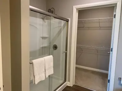 a bathroom with a glass shower with a towel at Near Osu Riverside No Steps Garage Parking! in Columbus