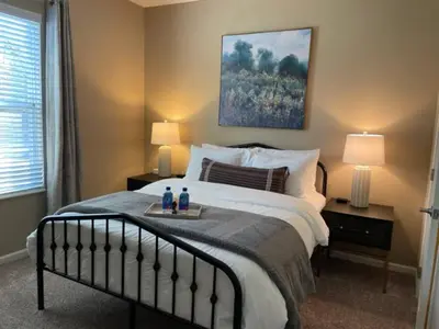 a bedroom with a bed with two lamps and two bottles at The Hilliard Executive No Steps Luxury Beds in Dublin