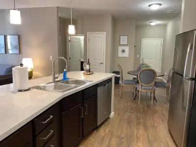 a kitchen with a sink and a refrigerator and a table at The Hilliard Executive No Steps Luxury Beds in Dublin