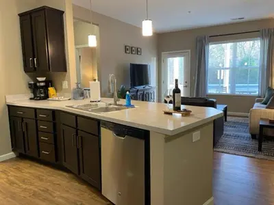 a kitchen with a counter top and a living room at The Hilliard Executive No Steps Luxury Beds in Dublin