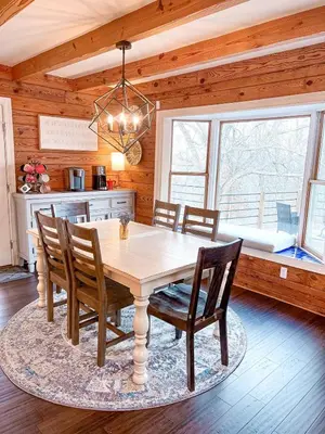 a dining room with a wooden table and chairs at Cabin Sweet Cabin in Burlington
