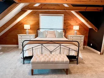 a bedroom with a bed in a attic at Cabin Sweet Cabin in Burlington