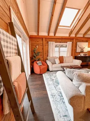 a living room with a couch and a table at Cabin Sweet Cabin in Burlington