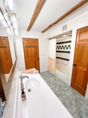 a bathroom with a sink and a shower at Cabin Sweet Cabin in Burlington