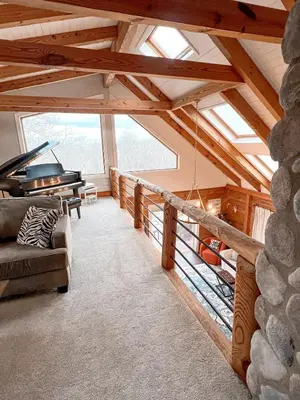 a living room with a couch and a piano at Cabin Sweet Cabin in Burlington