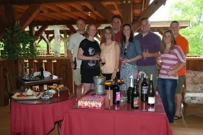 a group of people standing next to a table with wine bottles at The Inn at Dresden in Dresden