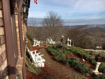 a view of a garden with white chairs and bushes at The Inn at Dresden in Dresden