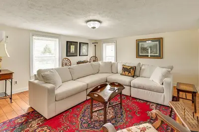 a living room with a white couch and a red rug at Georgetown Home Near Kentucky Horse Park! in Georgetown