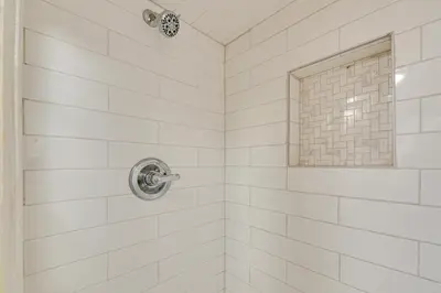a white tiled shower with a window at Georgetown Home Near Kentucky Horse Park! in Georgetown