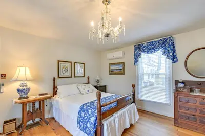 a bedroom with a bed and a chandelier and a window at Georgetown Home Near Kentucky Horse Park! in Georgetown