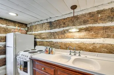 a kitchen with a sink and a white refrigerator at Georgetown Home Near Kentucky Horse Park! in Georgetown