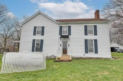 a white house with a fence in the yard at Georgetown Home Near Kentucky Horse Park! in Georgetown