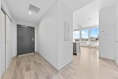 an empty room with white walls and a large door at Luxe Condo in Downtown Cleveland l 2 TV's l Parking in Cleveland