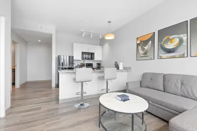 a living room with a couch and a table at Luxe Condo in Downtown Cleveland l 2 TV's l Parking in Cleveland