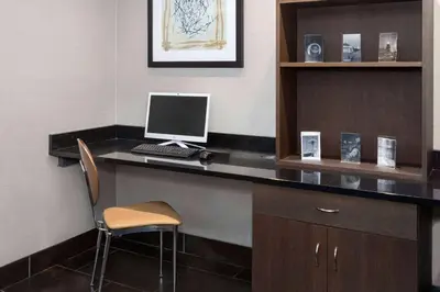 a office with a desk with a computer on it at Super 8 by Wyndham Copley Akron in Copley