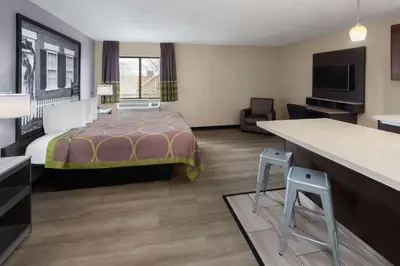 a hotel room with a bed and a desk at Super 8 by Wyndham Copley Akron in Copley