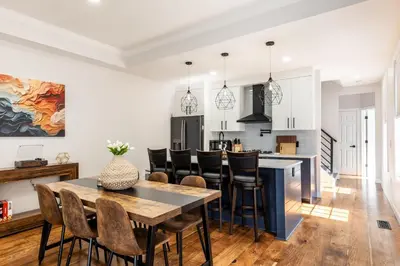 a kitchen and dining room with a table and chairs at Spacious & Cozy Central Cincinnati Home in Cincinnati